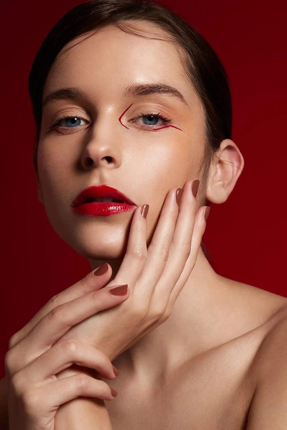 Close beauty portrait against a deep red background